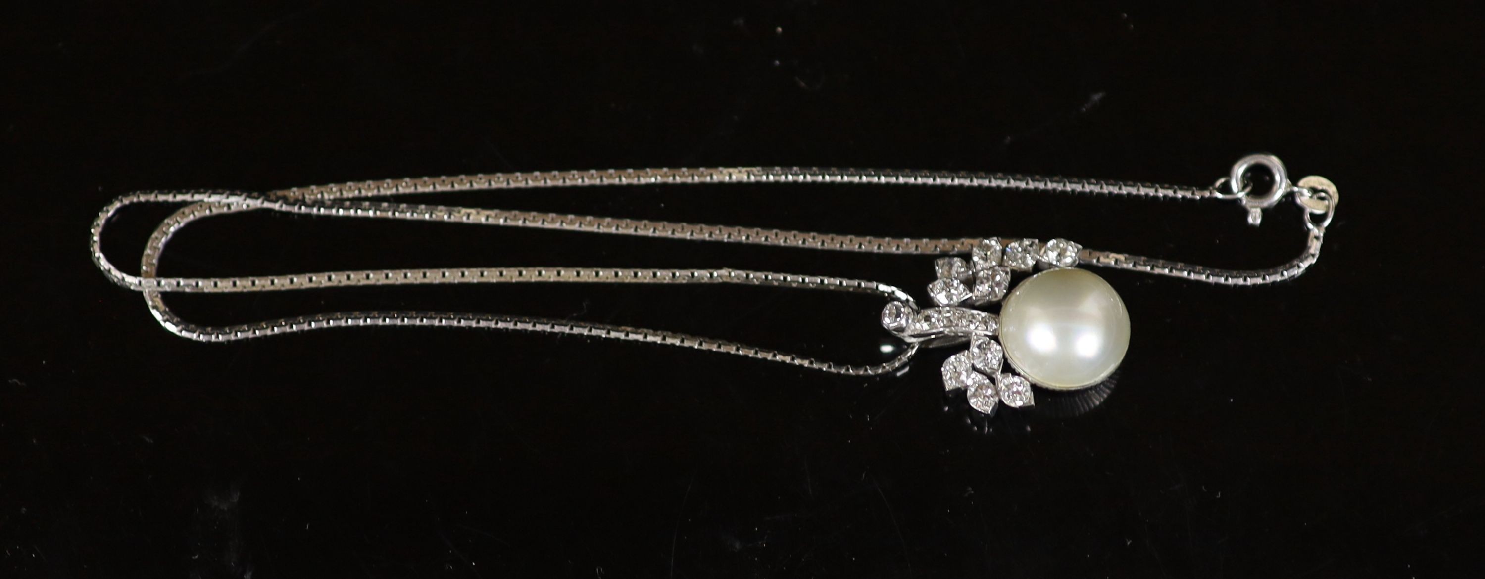 A white gold, mabe pearl and diamond cluster set pendant